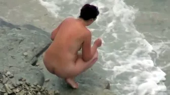 she is peeing in the water near the beach