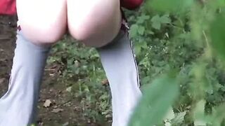 woman with dog peeing outdoors